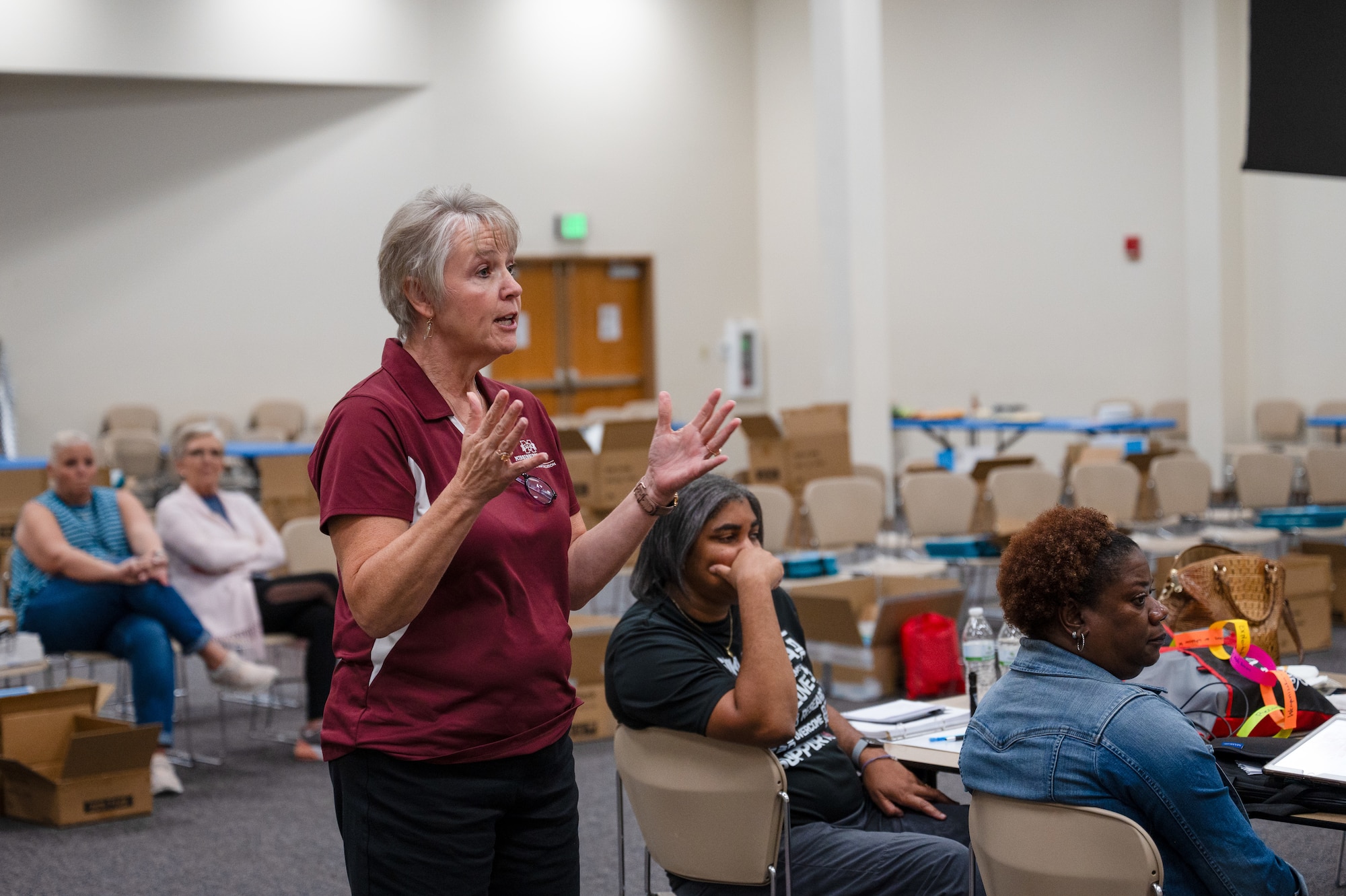 Shelly Hollis, Mississippi State University Center for Cyber Education director, addresses U.S. Air Force Col. Billy Pope, Jr., 81st Training Wing commander, during the MSU GenCyber camp at Keesler Air Force Base, Mississippi, June 7, 2024.