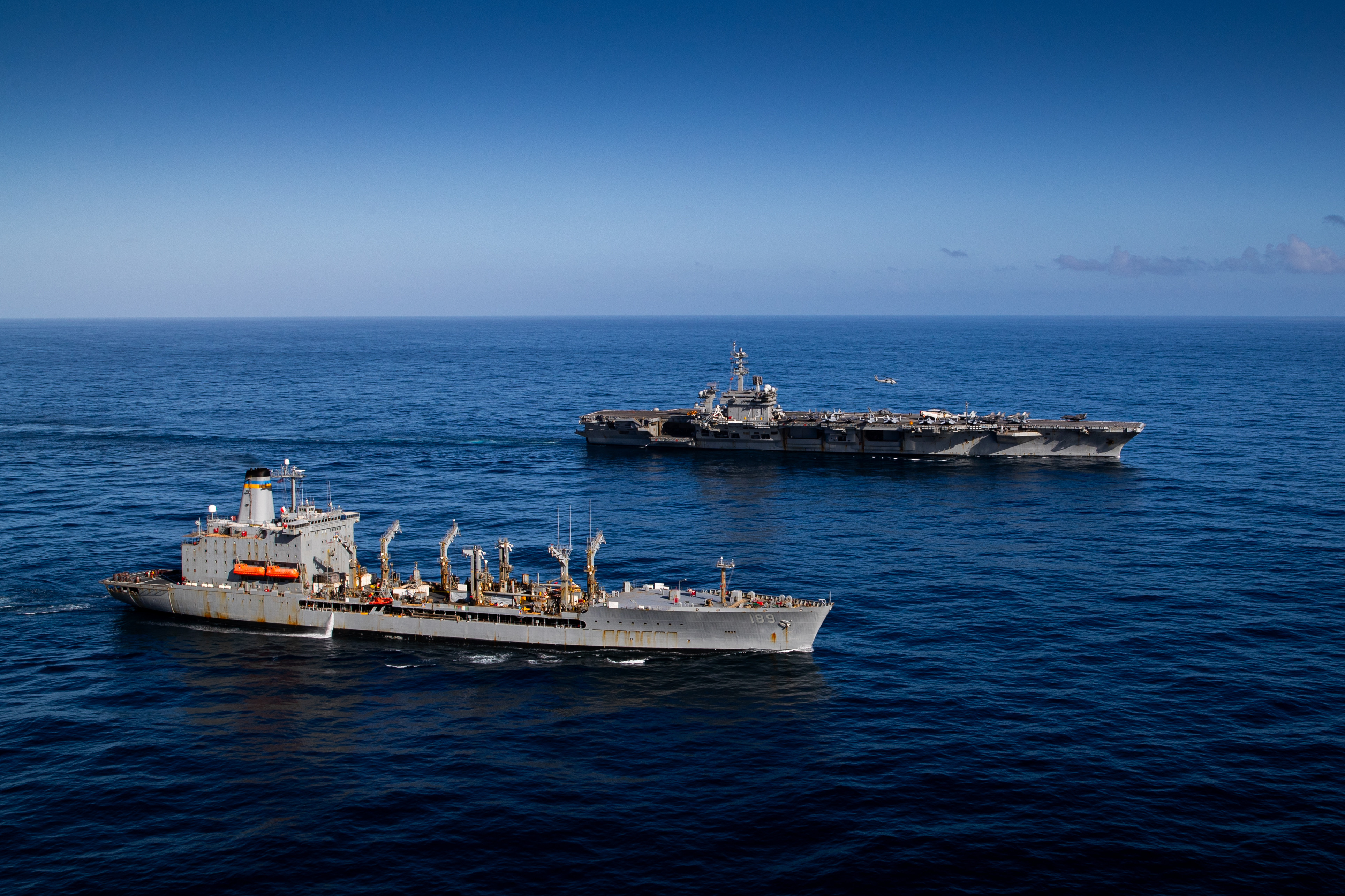Nimitz-class aircraft carrier USS George Washington (CVN 73) and fleet replenishment oiler USNS John Lenthall (T-AO 189) conduct a vertical replenishment while underway in the Pacific Ocean, June 14, 2024.