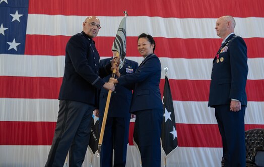  Col. Phoenix L. Hauser, right, takes the guidon from from Lt. Gen. David N. Miller, Jr, Space Operations Command commander, left, during a change of command ceremony.