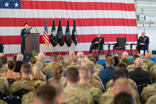  Col. Phoenix L. Hauser speaks to audience from a podium.