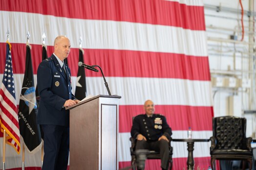  Col. Brett T. Swigert speaks to audience from a podium.