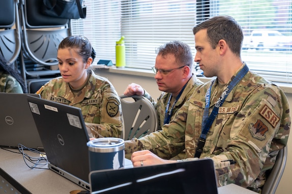 Airmen type on computers.