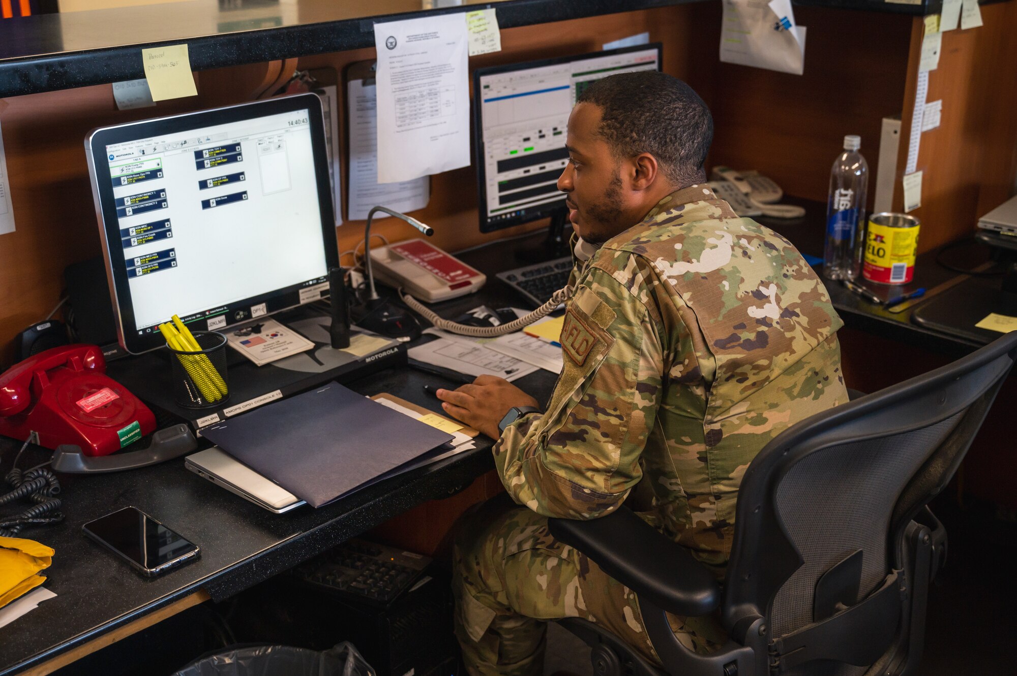 Senior Airman Nigel Harris, 8th Operational Support Squadron airfield management specialist, tests the crash phone