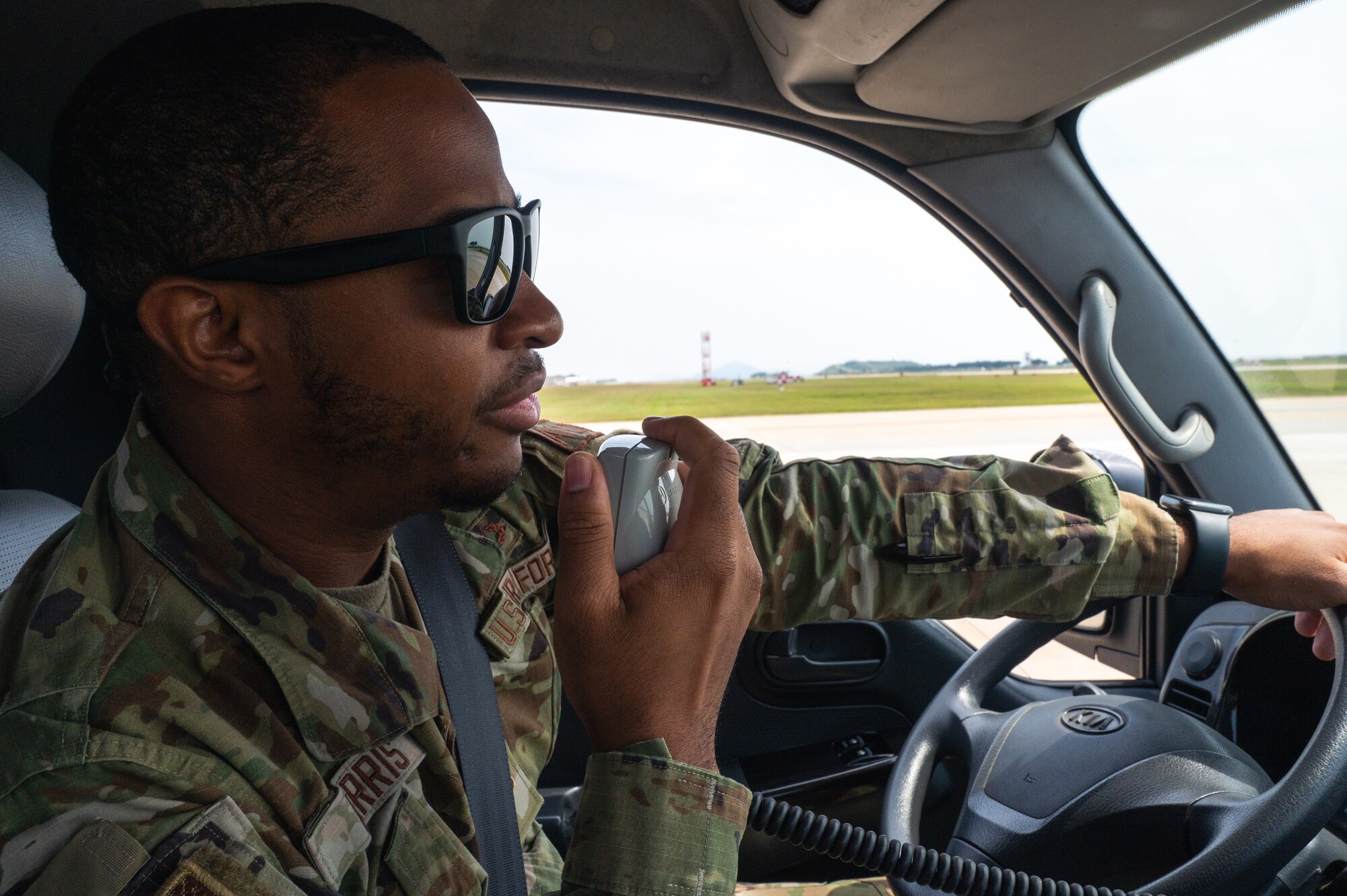 Senior Airman Nigel Harris, 8th Operational Support Squadron airfield management specialist, calls in on the radio on the flight line