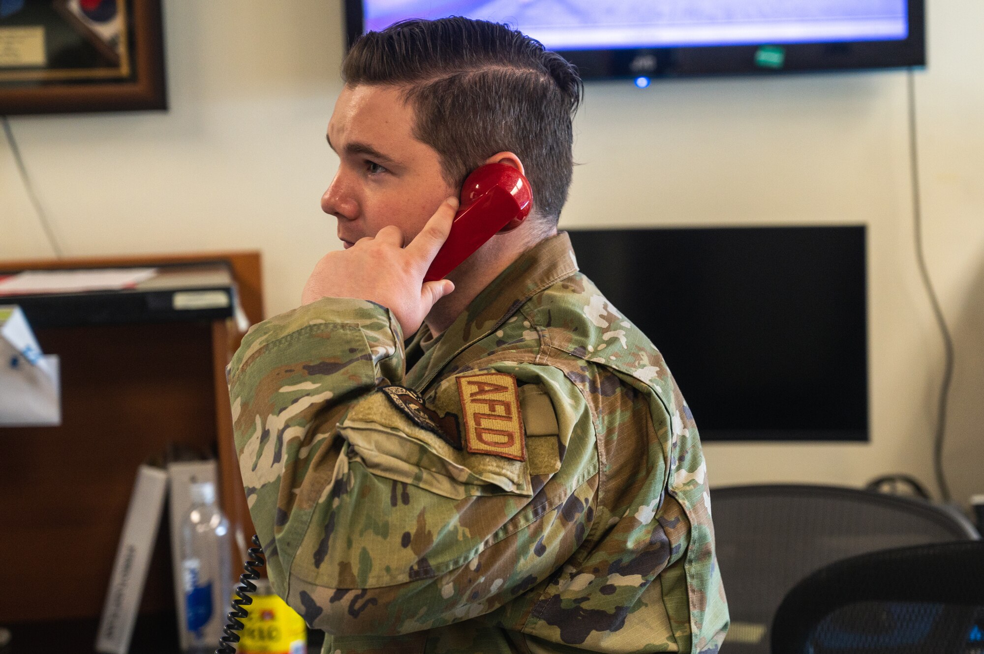 U.S. Air Force Staff Sgt. Cody Holmes, 8th Operational Support Squadron noncommissioned officer in charge of airfield management training, answers a call