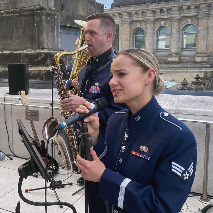 Vocalist Senior Airman Natalie Angst and saxophonist Staff Sgt. Joe Rulli, members of the U.S. Air Forces in Europe-Air Force Africas band, perform during a reception on the roof of the Bundestag, the German federal parliament building, as part of the activities related to the Berlin Innovation and Leadership in Aerospace trade show and air show, June 6, 2024, in Berlin, Germany. The band’s mission is to build relationships through a shared love of music. The band played at the industry days, ceremonial events at government centers in Berlin, and at the show’s public days. (U.S. Air Force photo by Senior Master Sgt. Dan Heaton)