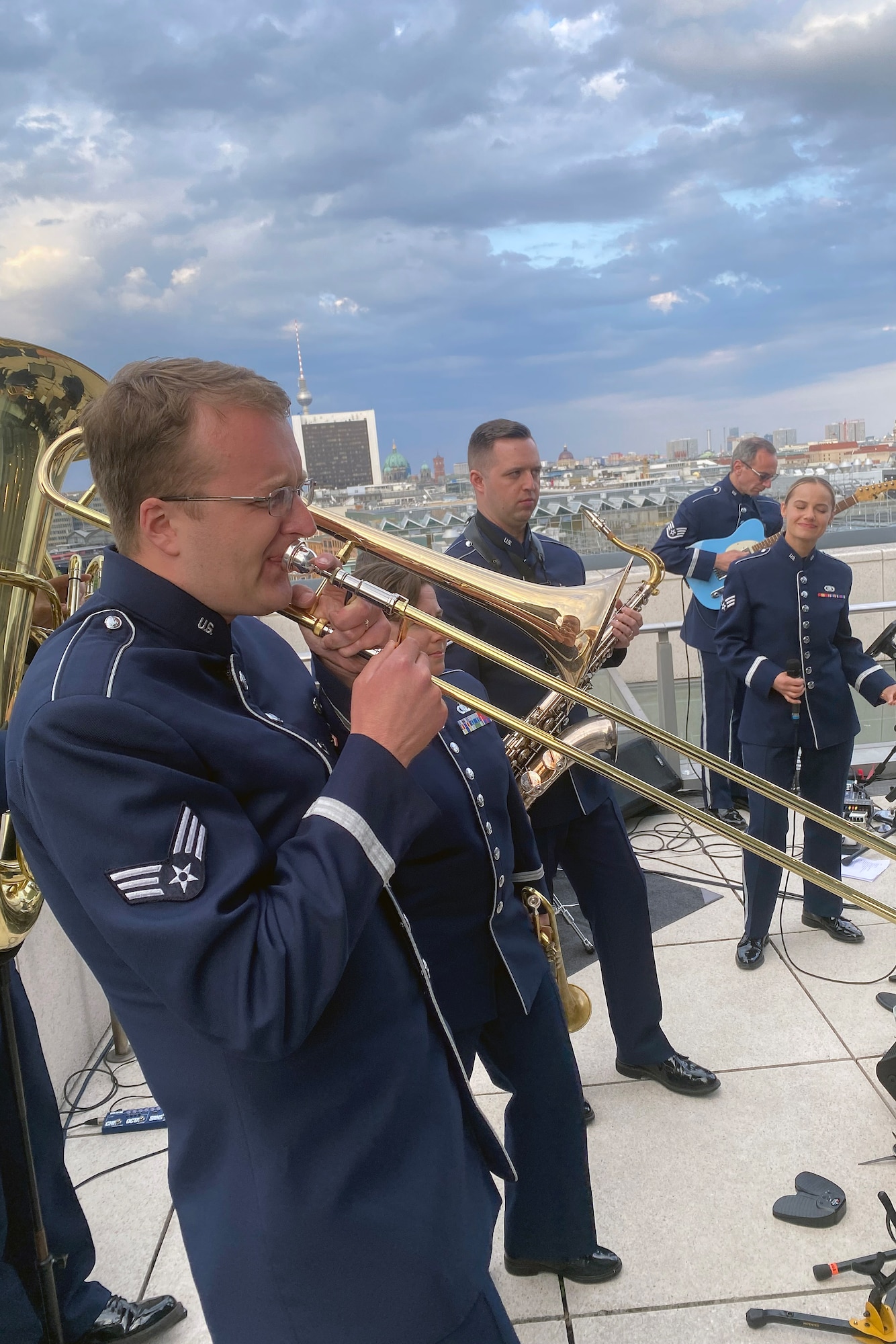 Trombone player Senior Airman Thomas Kelley, a member of the U.S. Air Forces in Europe-Air Forces Africa band, performs during a reception on the roof of the Bundestag, the German federal parliament building, as part of the activities related to the Berlin Innovation and Leadership in Aerospace trade show and air show, June 6, 2024, in Berlin, Germany. The band’s mission is to build relationships through a shared love of music. The band played at the industry days, ceremonial events at government centers in Berlin, and at the show’s public days. (U.S. Air Force photo by Senior Master Sgt. Dan Heaton)
