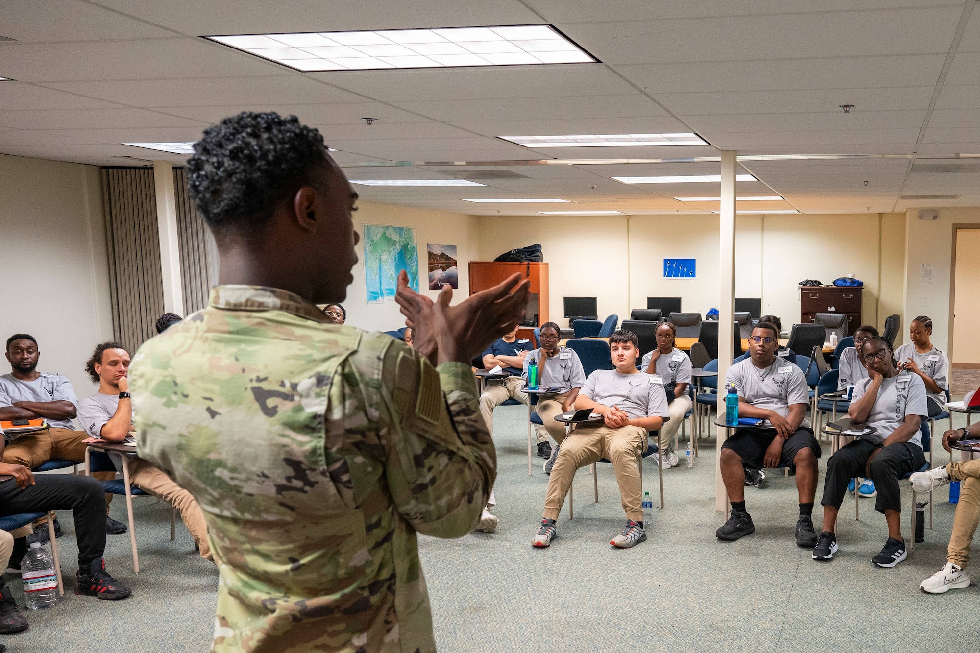 A man speaks to a classroom of people.
