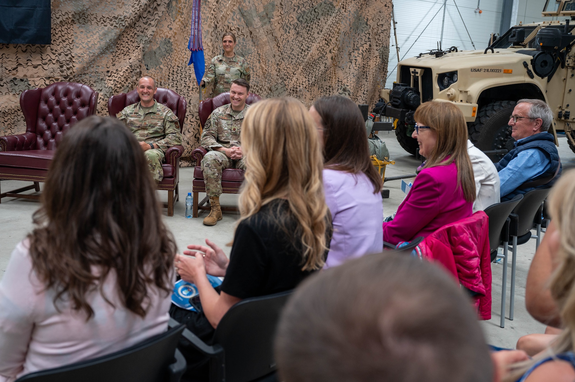 Military members smile at their families during a change of command ceremony.