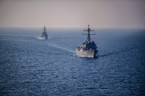 The guided-missile destroyer USS Mason (DDG 87) sails alongside the Japanese Murasame-class destroyer Akebono (DD 108) in the Gulf of Aden Nov. 25, 2023. Sailors from both ships trained on visit, board, search and seizure (VBSS) procedures, helicopter operations, and division tactic exercises, increasing interoperability between the two allies. DAs part of the Dwight D. Eisenhower Carrier Strike Group (IKECSG), the Mason is deployed to the U.S. 5th Fleet area of operations to support maritime security and stability in the Middle East. (U.S. Navy Photo by Mass Communication Specialist 3rd Class Samantha Alaman)