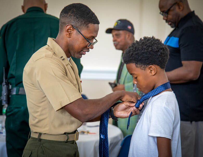 Col. Matthew McKinney, commanding officer and SgtMaj. Frank Kammer, base sergeant major, Marine Corps Logistics Base Albany, joined other base leaders and men from the local community for the annual Ties that Bind, June 14.

Hosted by Phoebe Putney Memorial Hospital Network of Trust, the event pairs young boys, many from homes without male role models or live-in fathers with distinguished men from the local community. The tie is a symbolic distinction and allows the male mentor to bond with their mentee while teaching him how to tie a necktie.