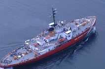 Aerial photo of Mackinaw in modern red paint scheme showing the icebreaker’s extreme width.