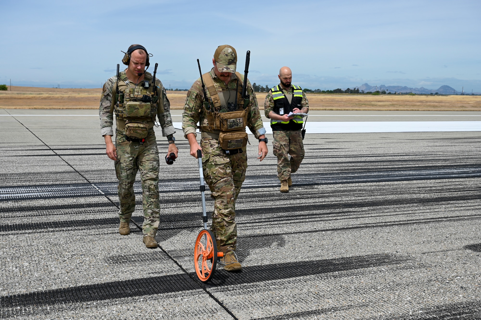 U.S. Air Force Master Sgt. Cameron Pointek, 9th Operations Support Squadron landing zone controller, U.S. Air Force Tech. Sgt. David Rost, 9th Operations Support Squadron landing zone controller, and U.S. Air Force Senior Master Sgt. Nathan Van Dyne, 9th Reconnaissance Wing Inspector General superintendent inspector general, cleared a U-2 Dragon Lady for take off from Beale Air Force Base, California, during EXERCISE READY DRAGON June 3, 2024.