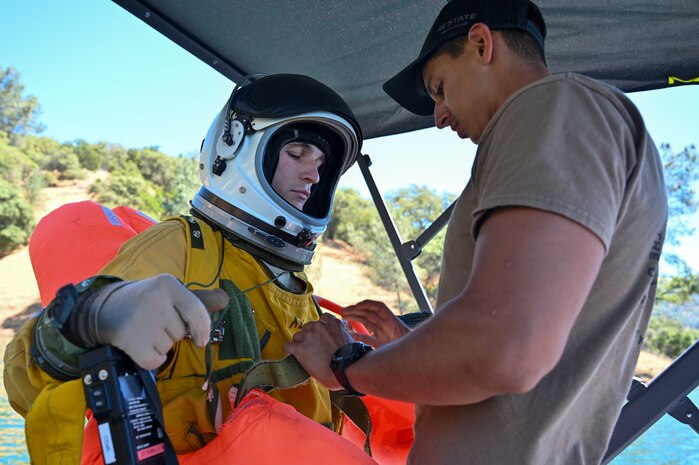 A U.S. Air Force pararescue specialist from the 129th Rescue Wing prepares a 99th Reconnaissance Squadron U-2 Dragon Lady pilot for a water rescue exercise at Englebright Lake, Smartsville, California on June 6, 2024.