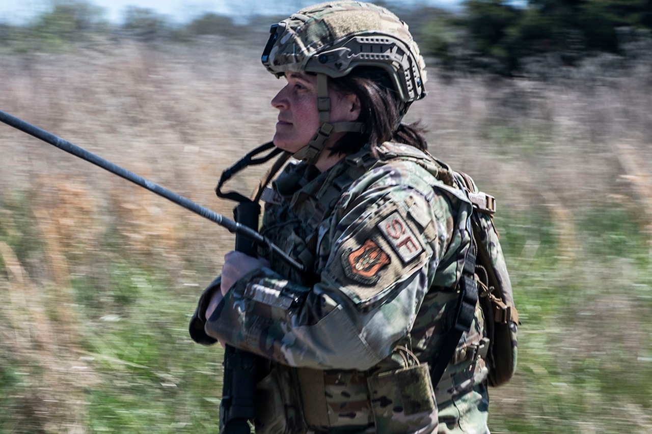 An airman runs outdoors.