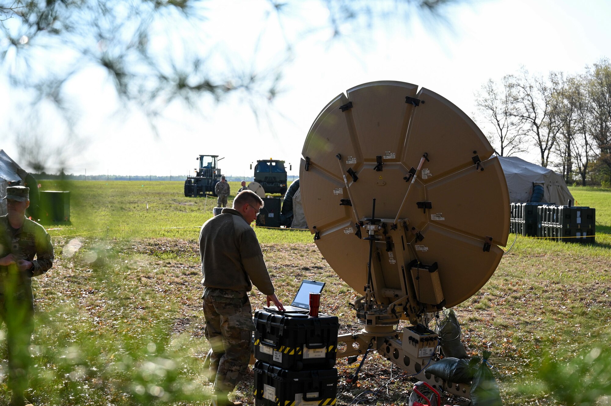 U.S. Air Force Tech. Sgt. Issac Adducchio, assigned to the 269th Combat Communications Squadron, Contacts Defense Infomraiton Systems Agency (DISA) to establish satellite communications at Alpena Combat Readiness Training Center, Michigan, May 14, 2024, as part of their larger annual training exercise. This annual training guarantees the readiness and deployability of both equipment and airmen, essential for optimizing our capabilities in the great power competition. (U.S. Air National Guard photo by Senior Airman Colin Simpson)