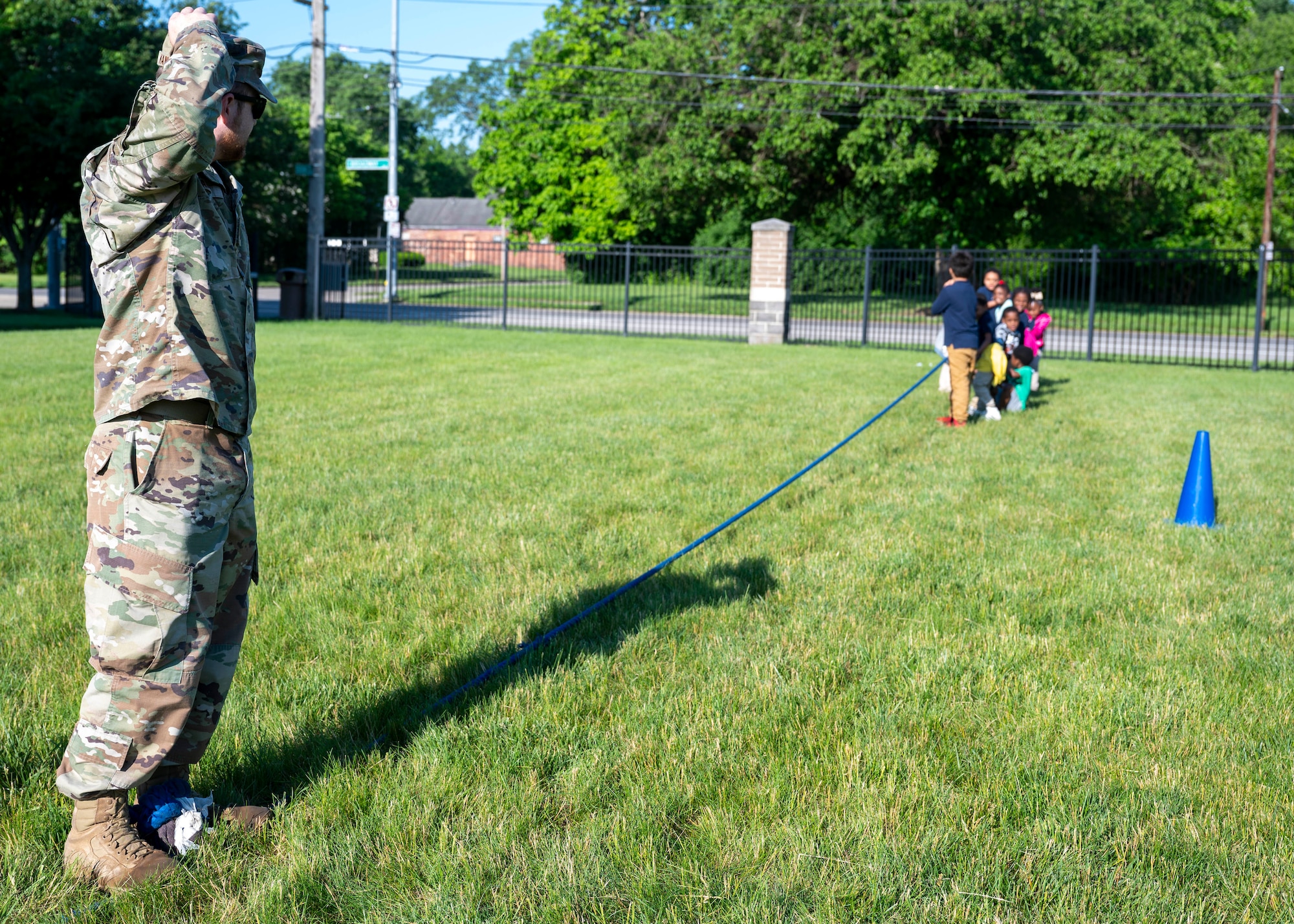 Captain Adam Kane, Air Force Life Cycle Management Center Fighters and Advanced Aircraft Directorate program manager, monitors the tug-of-war station during Edison Elementary School’s field day in Dayton, Ohio, May 16, 2024. Members of AFLCMC volunteer yearly with the local school to help with this large event. (U.S. Air Force photo by Staff Sgt. Mikaley Kline)