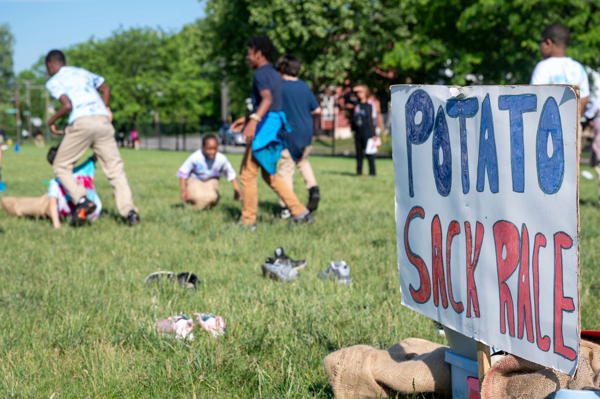 Edison Elementary School children participate in a potato sack race during the end of the school year field day in Dayton, Ohio, May 16, 2024. Members of AFLCMC volunteer yearly with the local school to help with this large event. (U.S. Air Force photo by Staff Sgt. Mikaley Kline)
