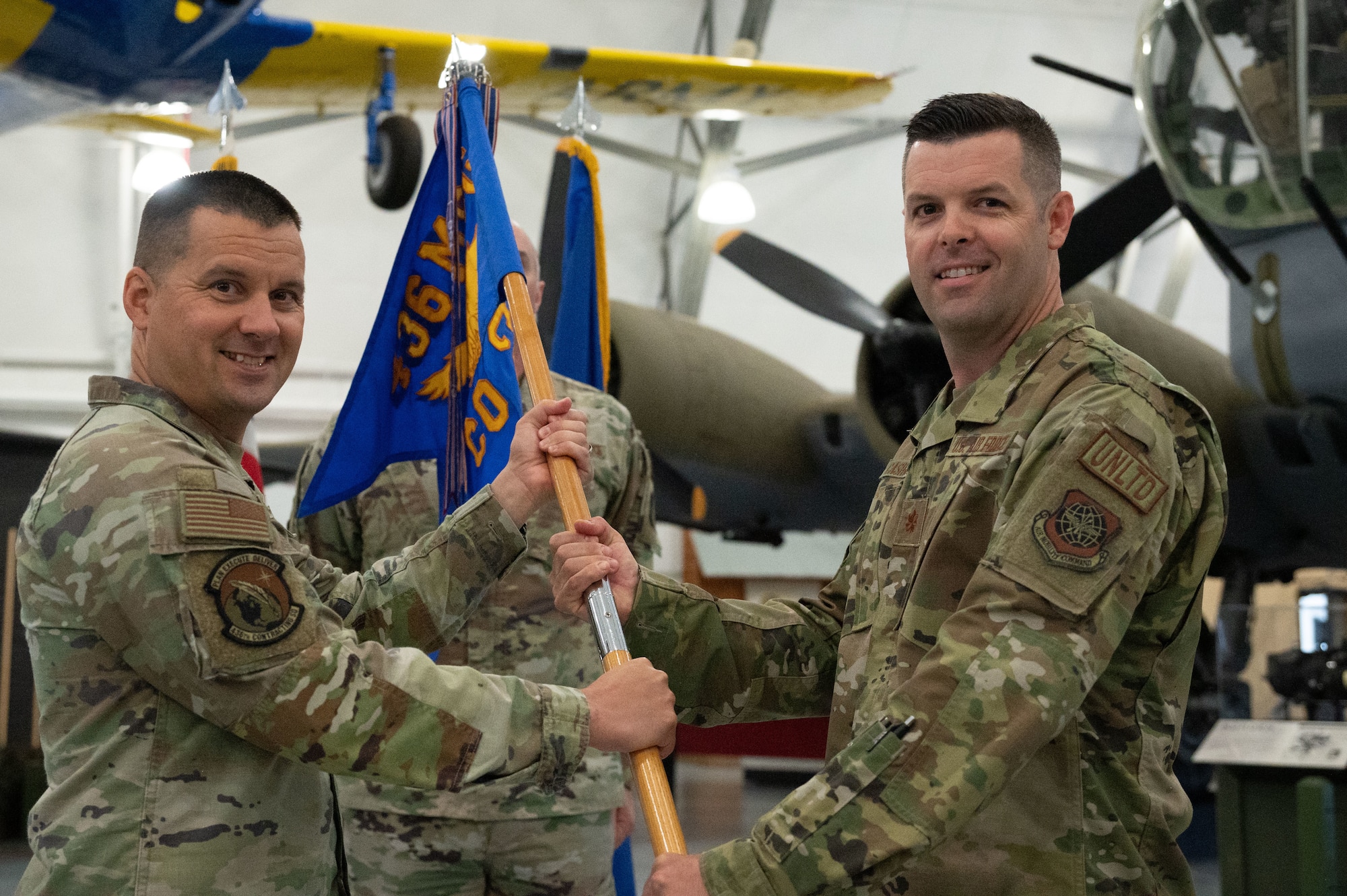 U.S. Air Force Col. Jason Holcomb, left, 436th Mission Support Group commander, passes the guidon to Maj. James Cashwell, incoming, 436th Contracting Squadron commander during the 436th CONS change of command ceremony at Dover Air Force Base, Delaware, June 18, 2024. The ceremony saw Maj. Ryan Coker relinquish command to Maj. James Cashwell. (U.S. Air Force photo by Dieondiere Jefferies)