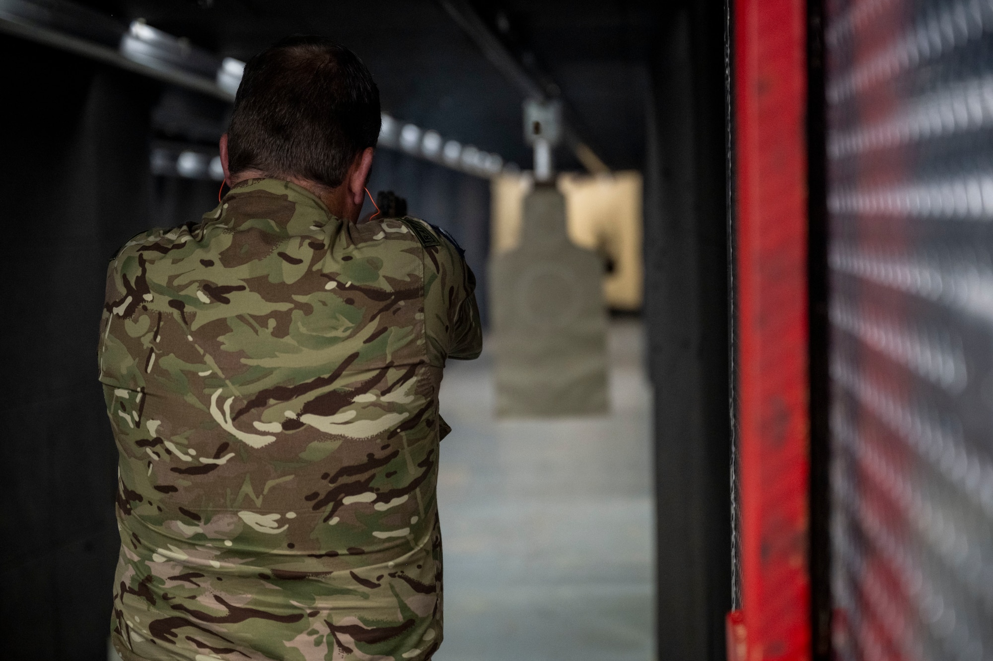 Photo of a Royal Air Force officer firing a weapon