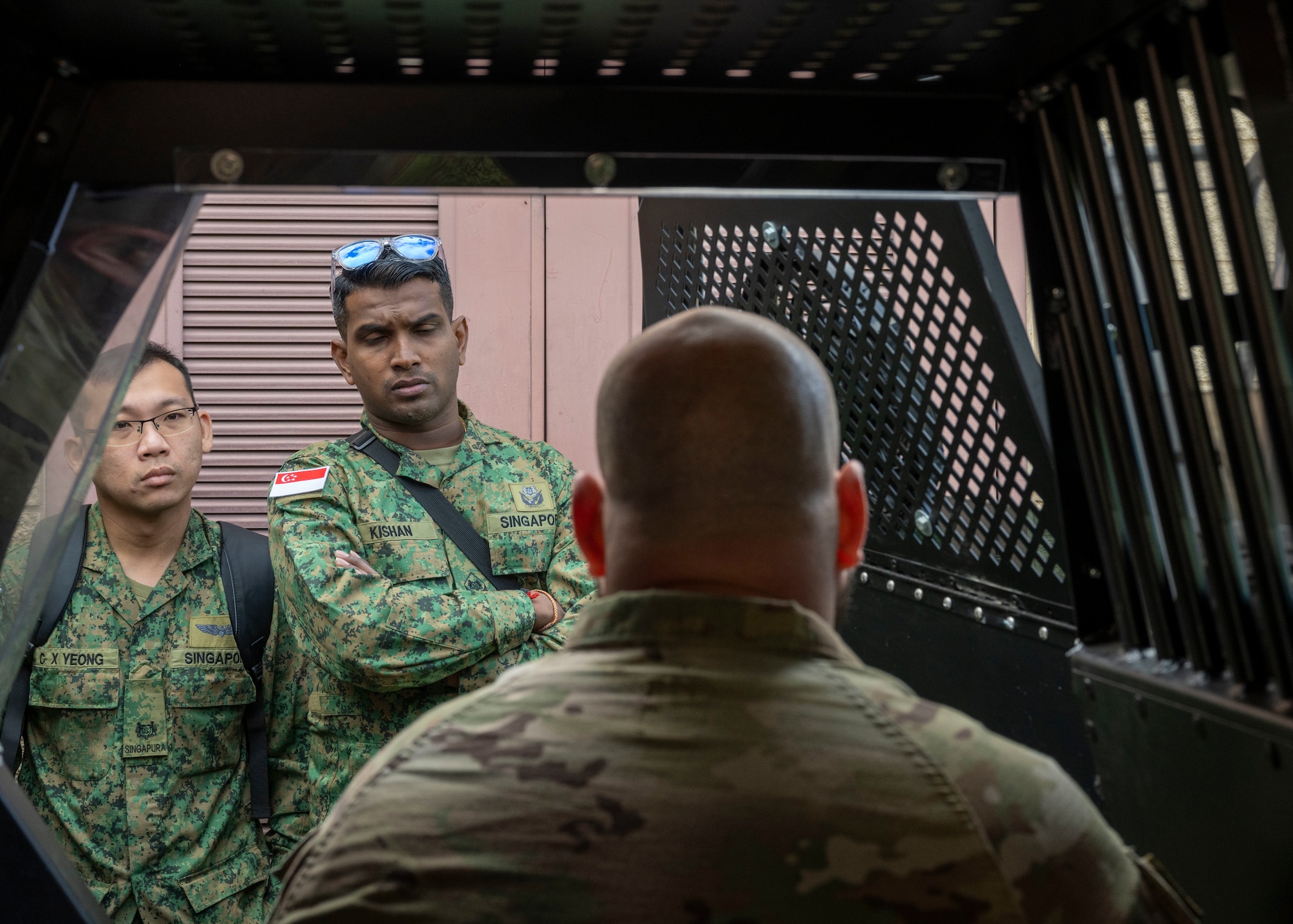 Photo of Pacific Defender attendees talking with a military working dog handler