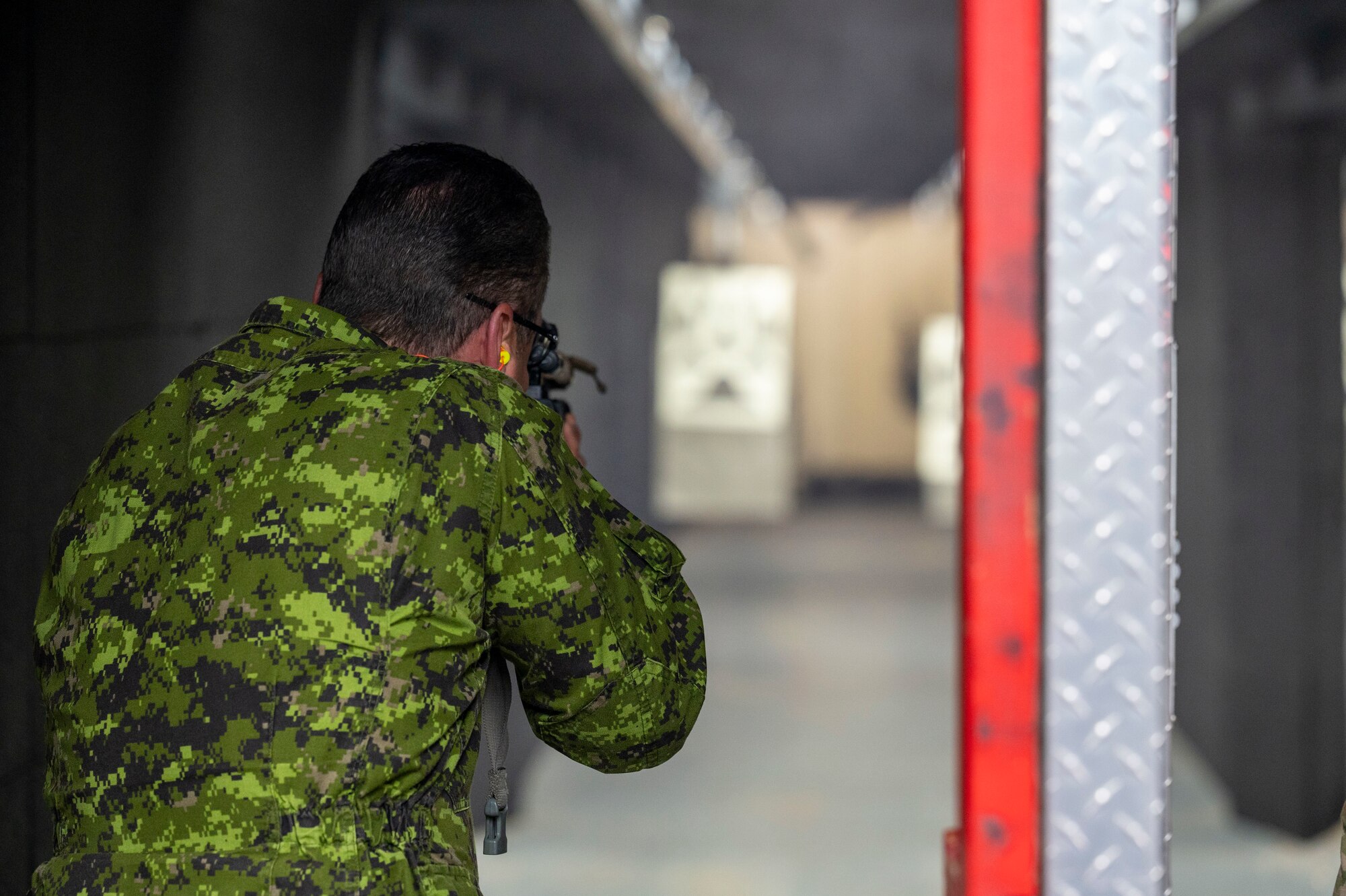 Photo of a Royal Canadian Air Force officer firing a weapon