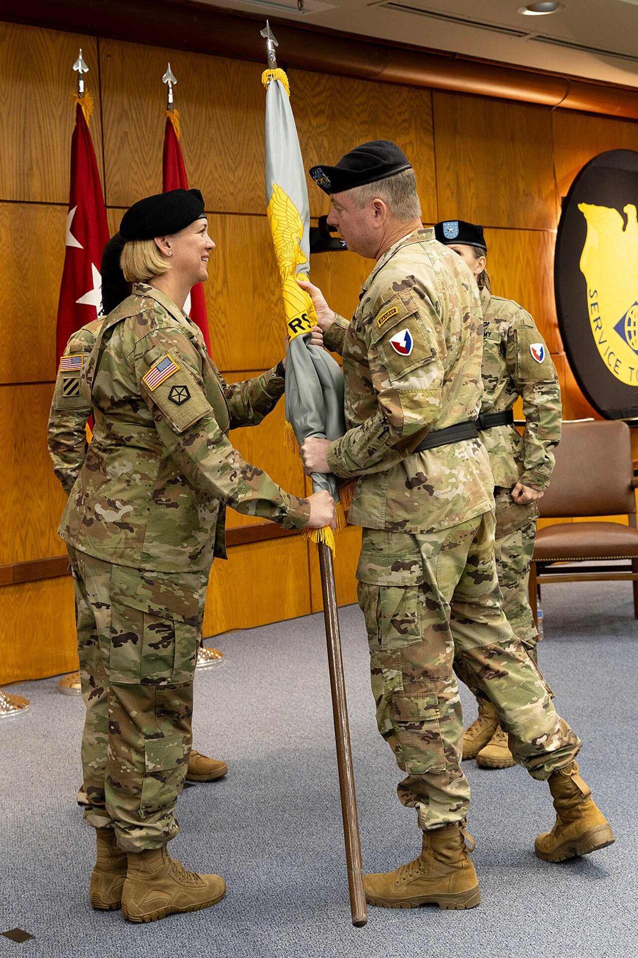 Lt. Gen. Christopher O. Mohan, U.S. Army Materiel Command deputy commanding general and acting commander, hands the U.S. Army Financial Management Command colors to Col. Michelle M. Williams as she takes command of the two-star organization at the Maj. Gen. Emmett J. Bean Federal Center in Indianapolis June 18, 2024. Williams, a St. Louis native, received a Regular Army commission into the Finance Corps in 1999 as a distinguished military graduate of the Florida Institute of Technology’s Army Reserve Officer Training Corps program after earning a Bachelor of Science in business administration. (U.S. Army photo by Bradley A. Staggs)