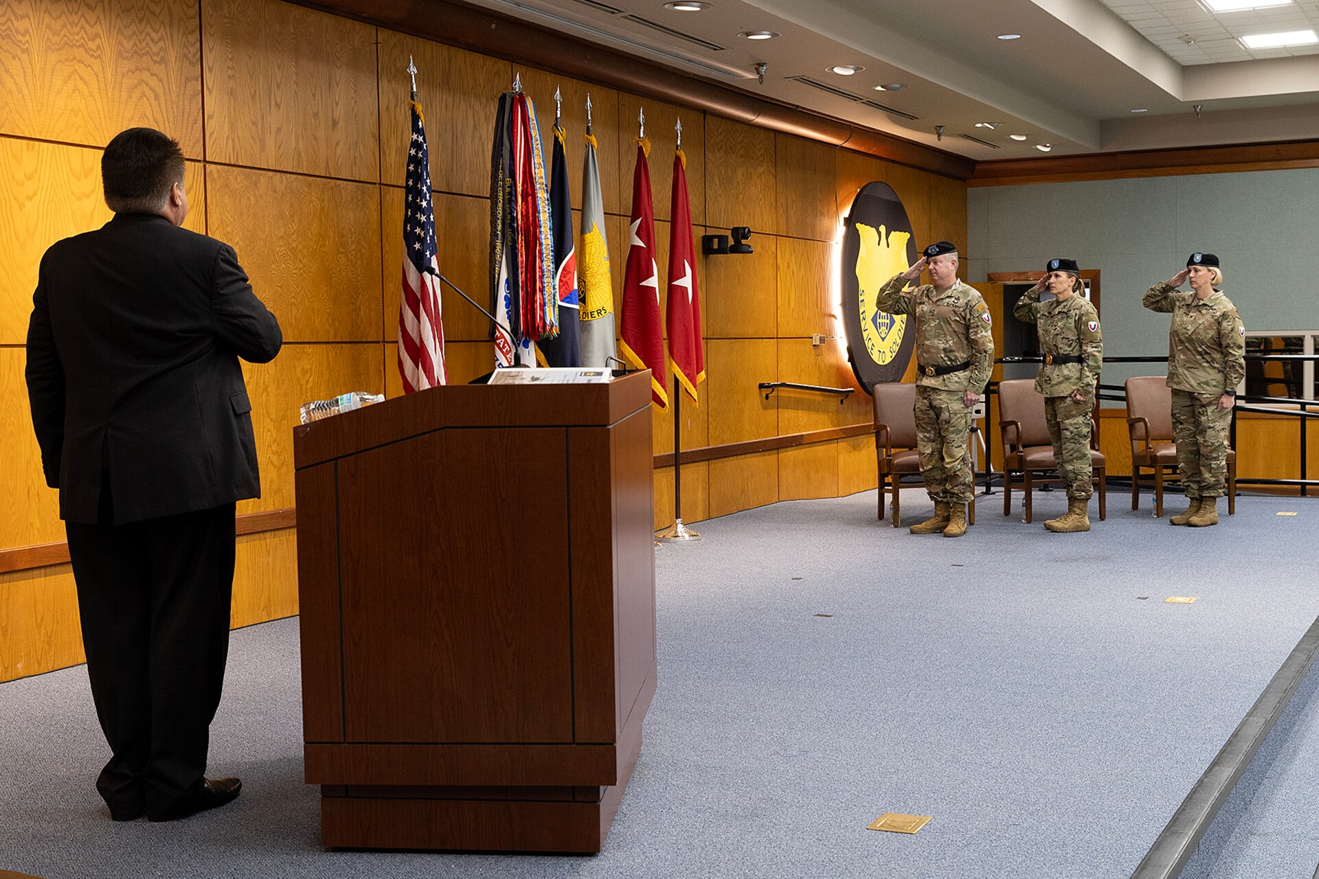 Mark Ehinger, U.S. Army Financial Management Command operations specialist; Lt. Gen. Christopher O. Mohan, U.S. Army Materiel Command deputy commanding general and acting commander; Brig. Gen. Paige M. Jennings, outgoing USAFMCOM commanding general; and Col. Michelle M. Williams, incoming USAFMCOM commander, salute the U.S. flag during a rendition of the National Anthem by a 38th Infantry Division brass quintet during a USAFMCOM change of command ceremony at the Maj. Gen. Emmett J. Bean Federal Center in Indianapolis June 18, 2024. The quintet was let by Staff Sgt. Paul Mergen. (U.S. Army photo by Bradley A. Staggs)
