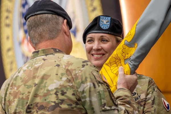 Lt. Gen. Christopher O. Mohan, U.S. Army Materiel Command deputy commanding general and acting commander, hands the U.S. Army Financial Management Command colors to Col. Michelle M. Williams as she takes command of the two-star organization at the Maj. Gen. Emmett J. Bean Federal Center in Indianapolis June 18, 2024. USAFMCOM delivers precision enterprise-wide financial operations to integrate, synchronize and sustain the battlefield through the Joint Strategic Support Area and directly supports the Office of the Assistant Secretary of the Army for Financial Management and Comptroller in their role as the principal advisor on all matters related to financial management and comptrollership. (U.S. Army photo by Mark R. W. Orders-Woempner)