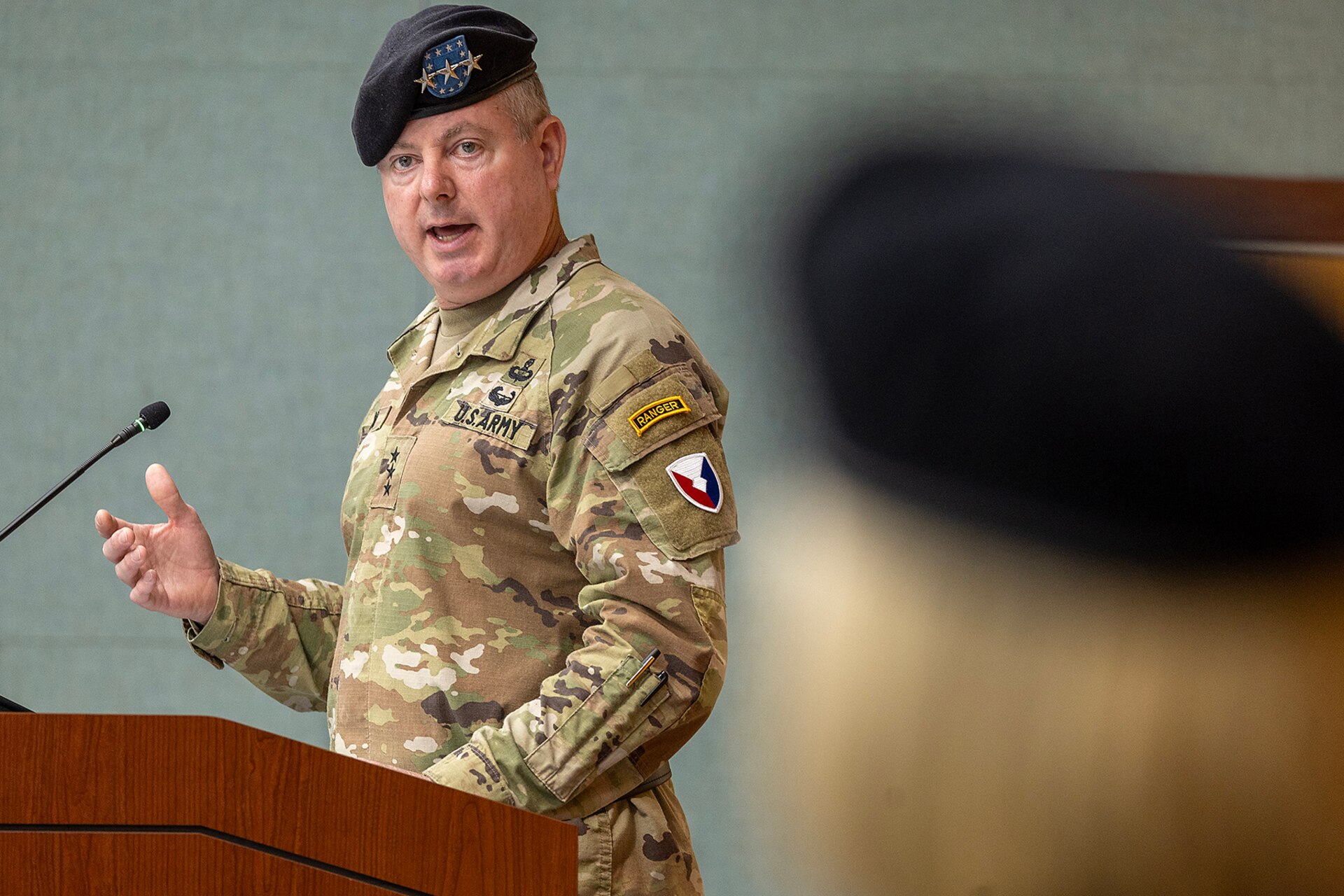Lt. Gen. Christopher O. Mohan, U.S. Army Materiel Command deputy commanding general and acting commander, delivers remarks as Col. Michelle M. Williams, U.S. Army Financial Management Command commander, listens during USAFMCOM’s change of command ceremony at the Maj. Gen. Emmett J. Bean Federal Center in Indianapolis June 18, 2024. USAFMCOM delivers precision enterprise-wide financial operations to integrate, synchronize and sustain the battlefield through the Joint Strategic Support Area and directly supports the Office of the Assistant Secretary of the Army for Financial Management and Comptroller in their role as the principal advisor on all matters related to financial management and comptrollership. (U.S. Army photo by Mark R. W. Orders-Woempner)