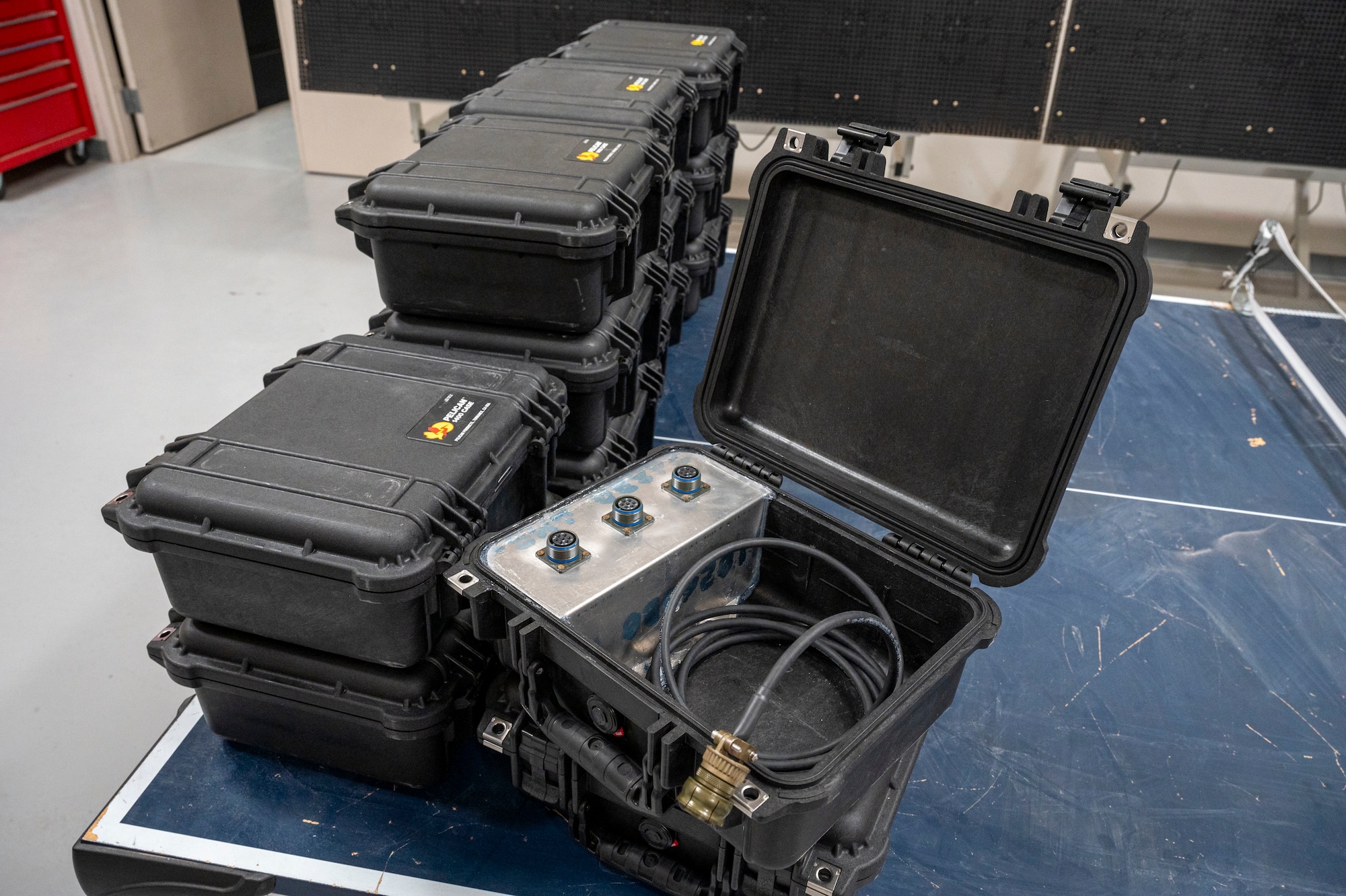 A series of modified communications W cords can be seen housed in pelican cases at Holloman Air Force Base, New Mexico, May 20, 2024. Allowing up to three aircrew members to speak with a pilot, the W cord can be used to train newer personnel and troubleshoot any discrepancies that may occur during operations. (U.S. Air Force photo by Senior Airman Isaiah Pedrazzini)