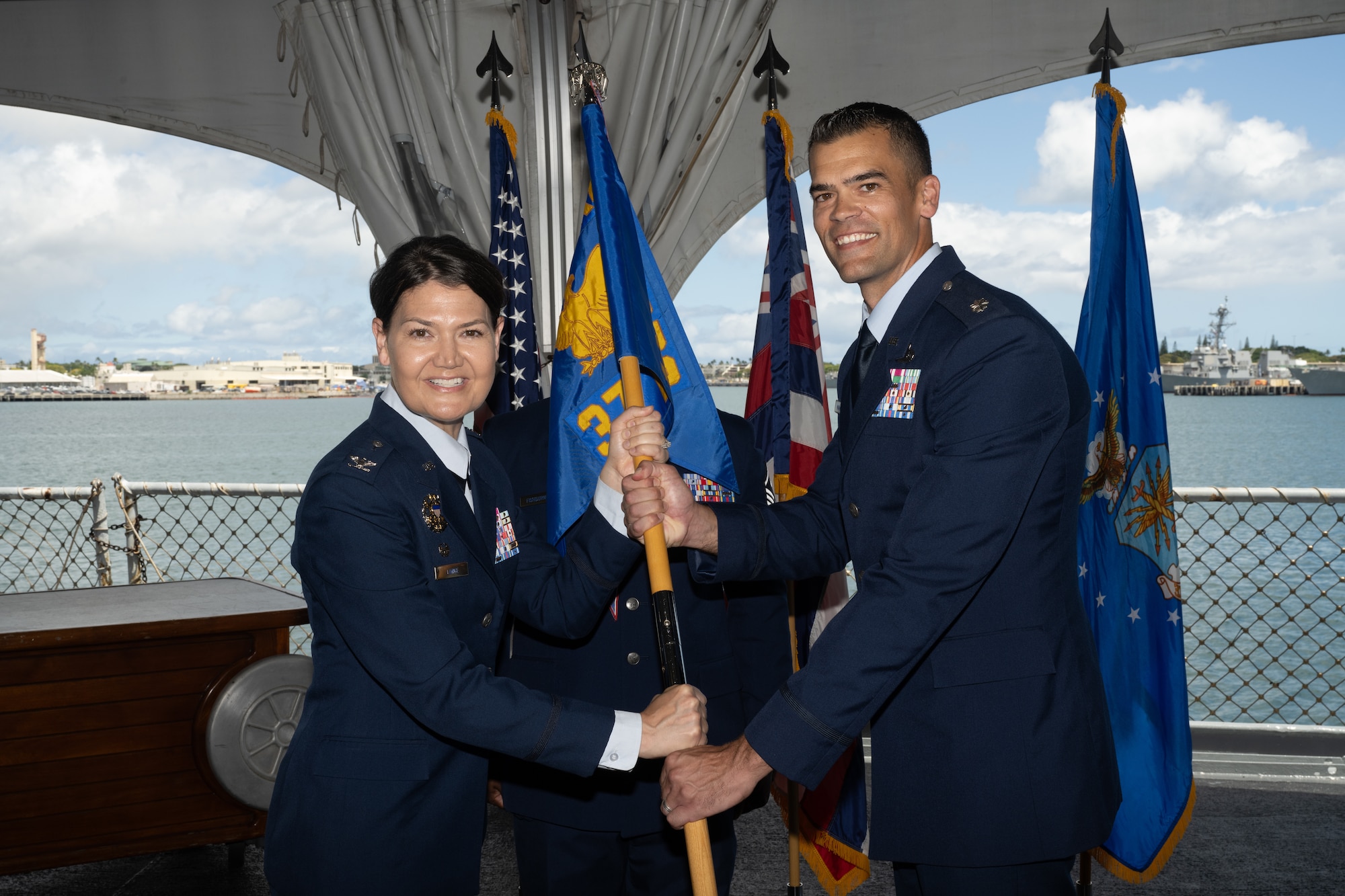 An Airman passes a guidon signifying the transfer of power during a change of command ceremony.