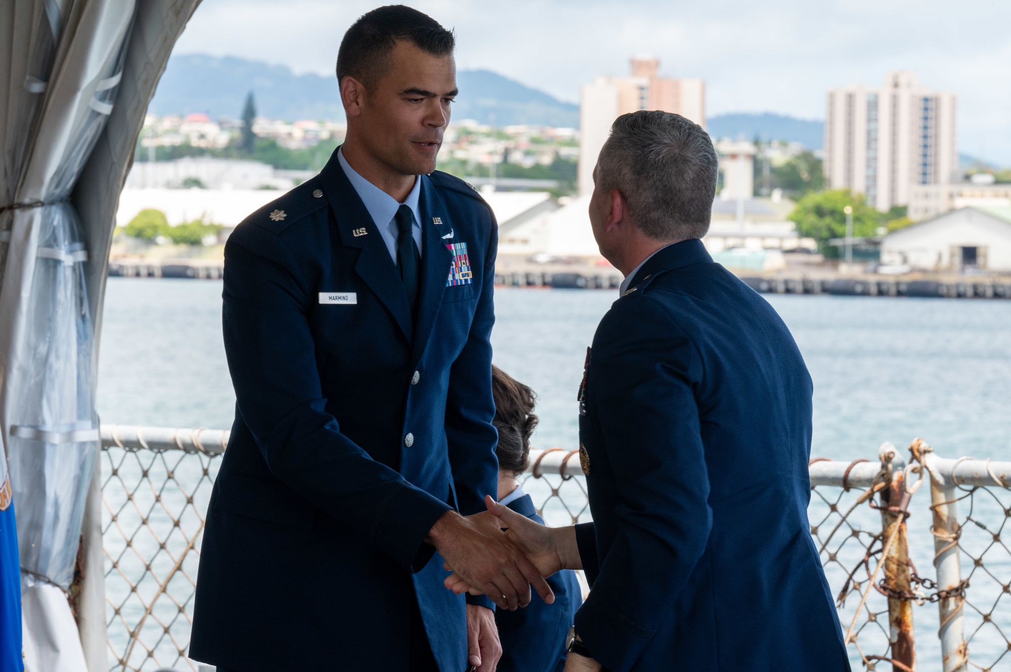 Two men shake hands after a change of command ceremony
