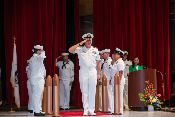 Rear Adm. Brent DeVore, commander, Joint Region Marianas, renders a salute during the JRM Change of Command Ceremony held at the Naval Base Guam theater, June 6.