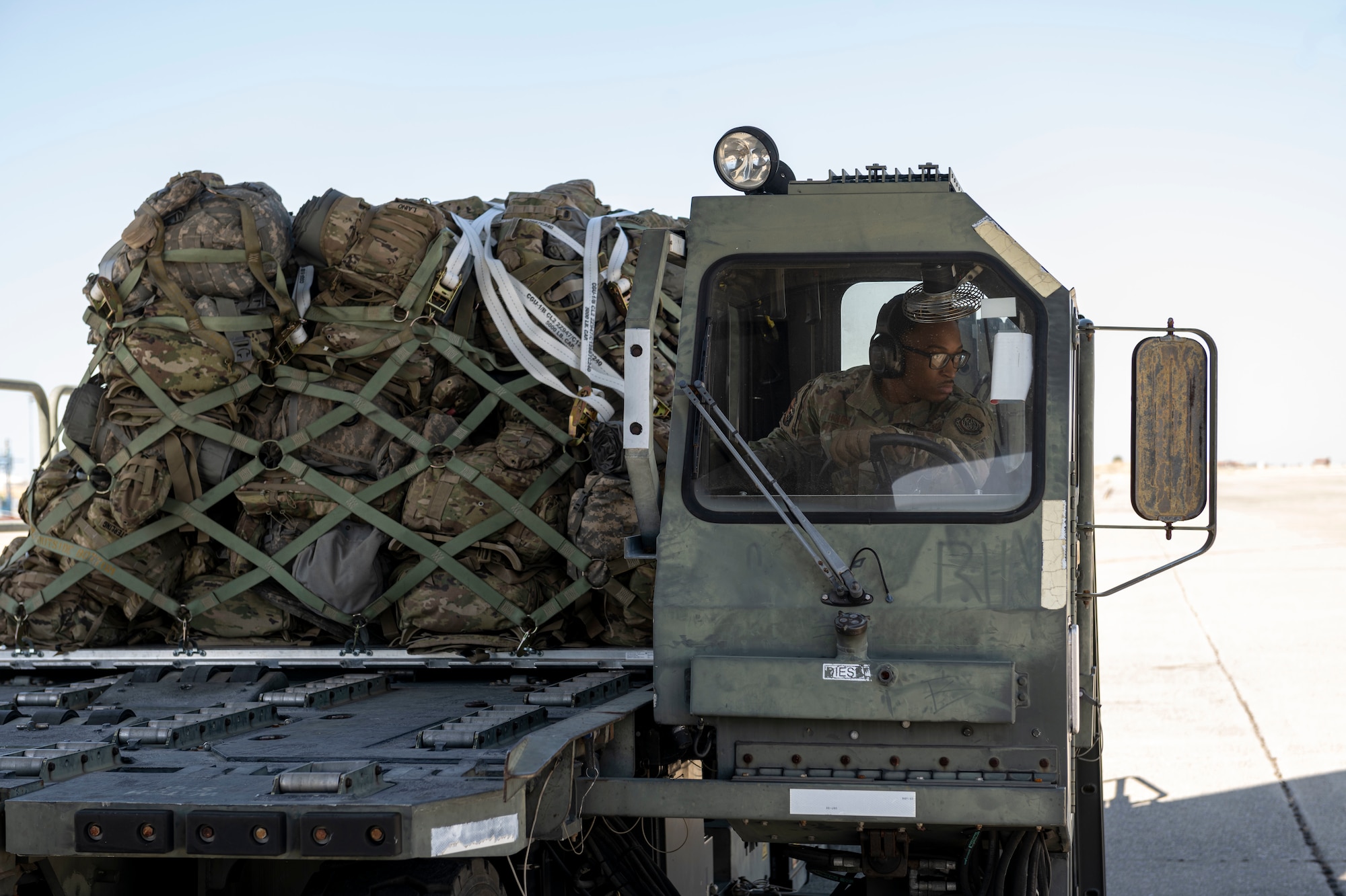 man drives K-Loader on the flight line