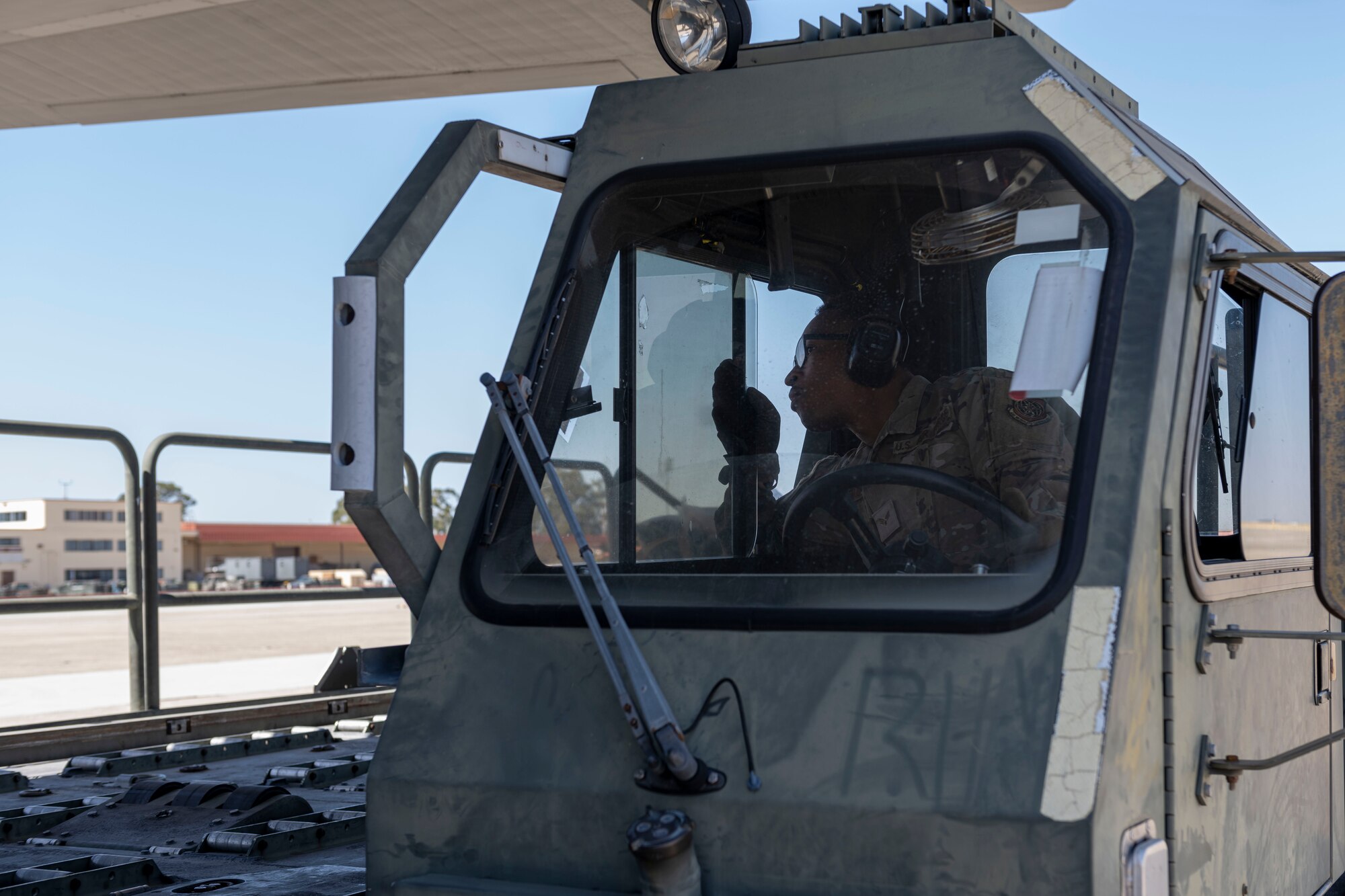 man drives K-Loader on the flight line