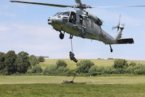 An Explosive Ordnance Disposal (EOD) technician assigned to EOD Mobile Unit Twelve fast-ropes from an MH-60S helicopter assigned to Helicopter Sea Combat Squadron 21 at Truppenübungsplatz Putlos, Germany, during Baltic Operations Exercise (BALTOPS), June 14, 2024.