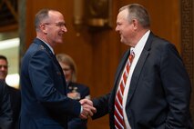 U.S. military service member greets Senate chair.
