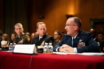 U.S. military service members sitting during a hearing.