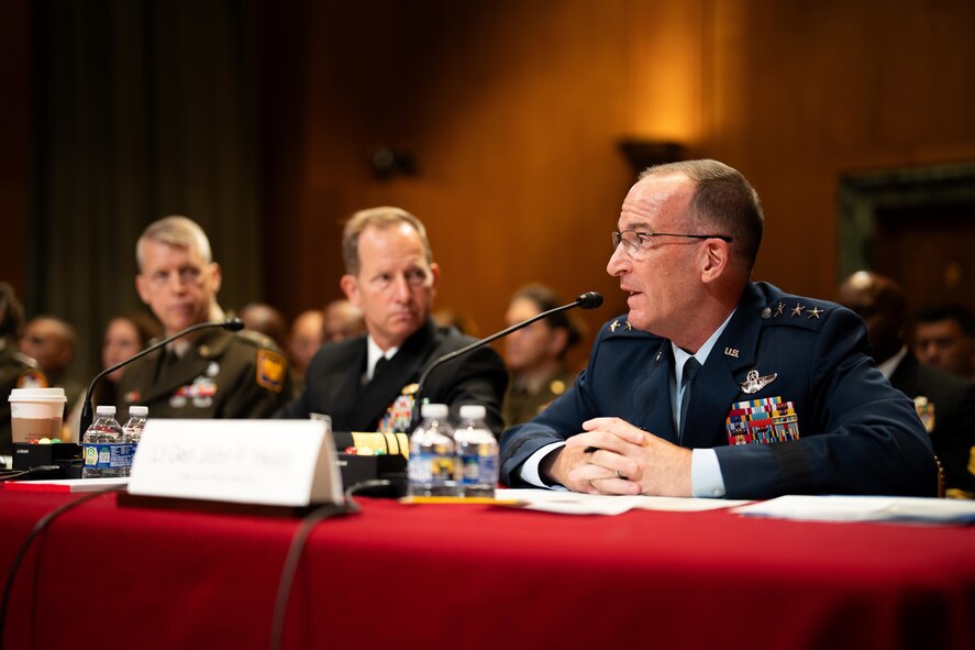 U.S. military service members sitting during a hearing.