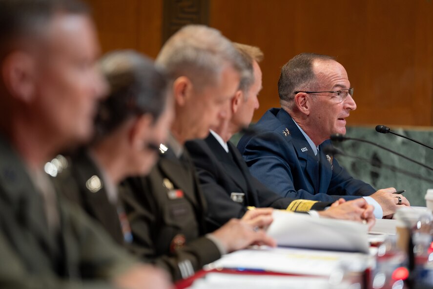 U.S. military service members sitting during a hearing.
