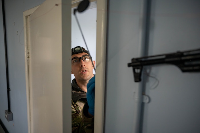 man looking through a trapped door