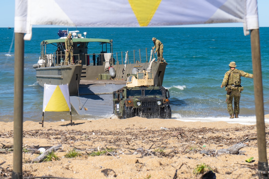 U.S. Marine Corps Lance Cpl. Josue RobleroGonzalez, a motor transport operator with Combat Logistics Battalion 5 (Reinforced), Marine Rotational Force – Darwin 24.3, drives a HMMWV from a Royal Australian Navy Landing Craft assigned to HMAS Adelaide (L01) on to Cowley Beach for an amphibious ship-to-shore operation during the Wet and Dry Exercise Rehearsal at Cowley Beach Training Area, QLD, Australia, June 16, 2024. During WADER, elements from the MRF-D Marine Air-Ground Task Force will conduct MV-22B Osprey deck landing qualifications, a live-fire deck shoot, medical subject matter expert exchanges, enhance amphibious fires, command and control, and initiate a ship-to-shore movement in order to set conditions for future operational tasking. RobleroGonzalez is a native of North Carolina. (U.S. Marine Corps photo by Gunnery Sgt. Kassie McDole)