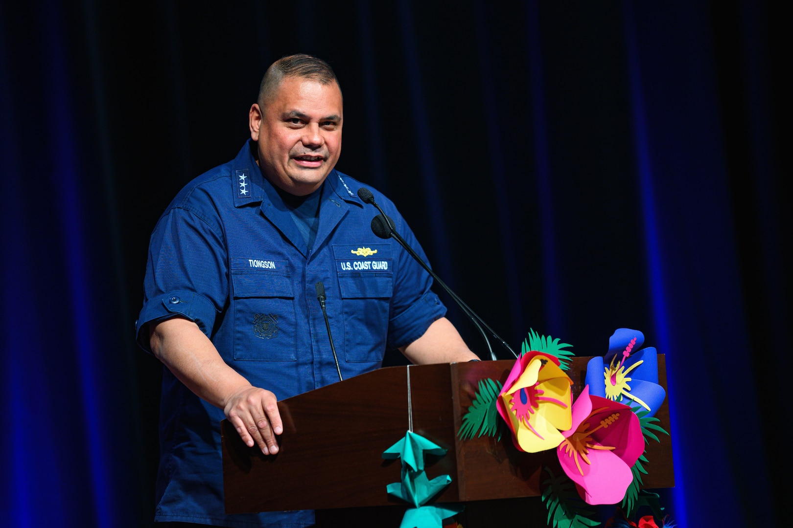 Vice Admiral Andrew Tiongson is standing behind a podium giving remarks.