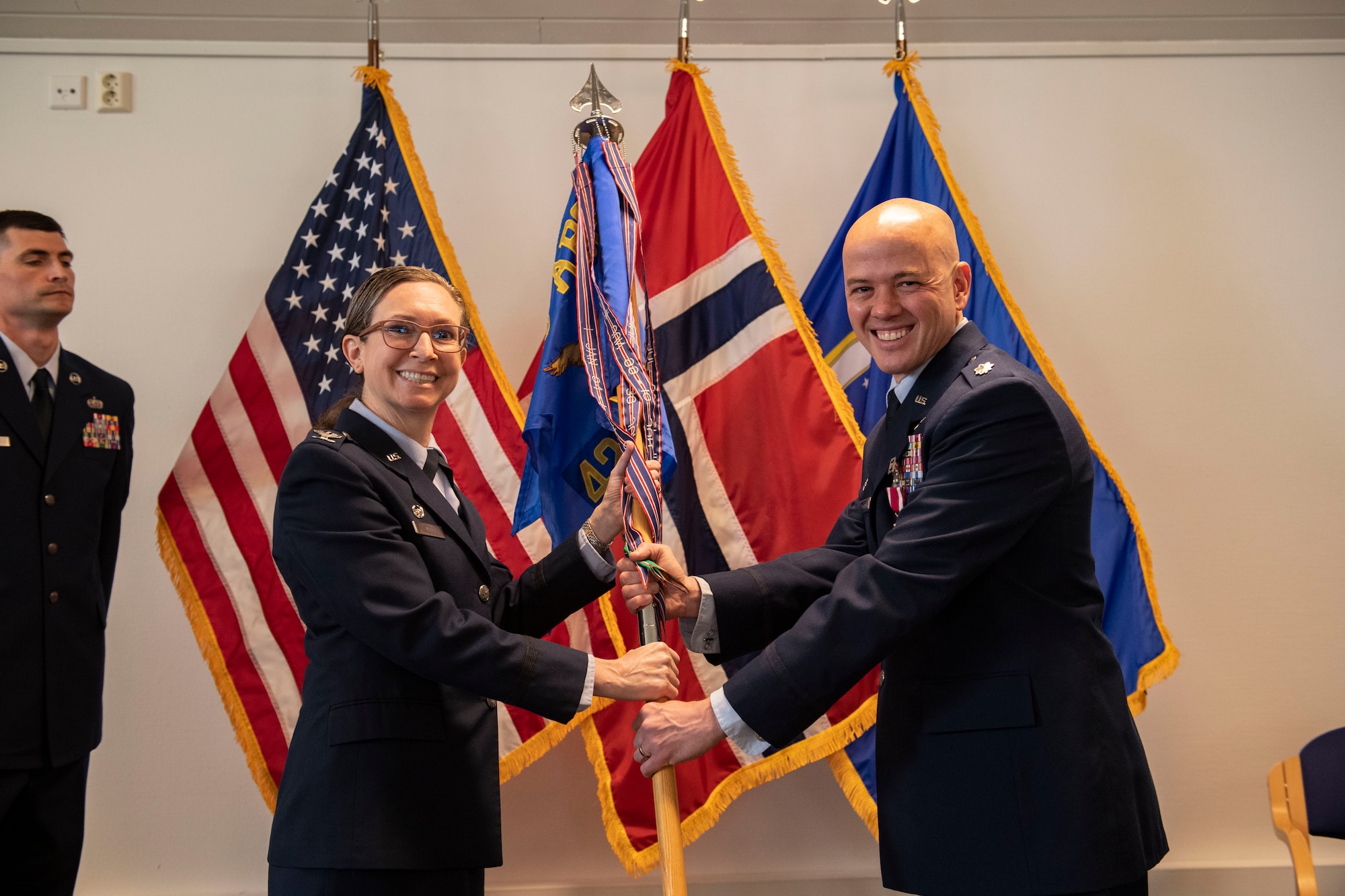 Col. Valarie A. Long, 423d Air Base Group commander, left, presents Lt. Col. Joseph H. Manning, 426th Air Base Squadron outgoing commander, with a Meritorious Service Medal during the 426th ABS change of command ceremony on Jåttå Military Compound, Norway