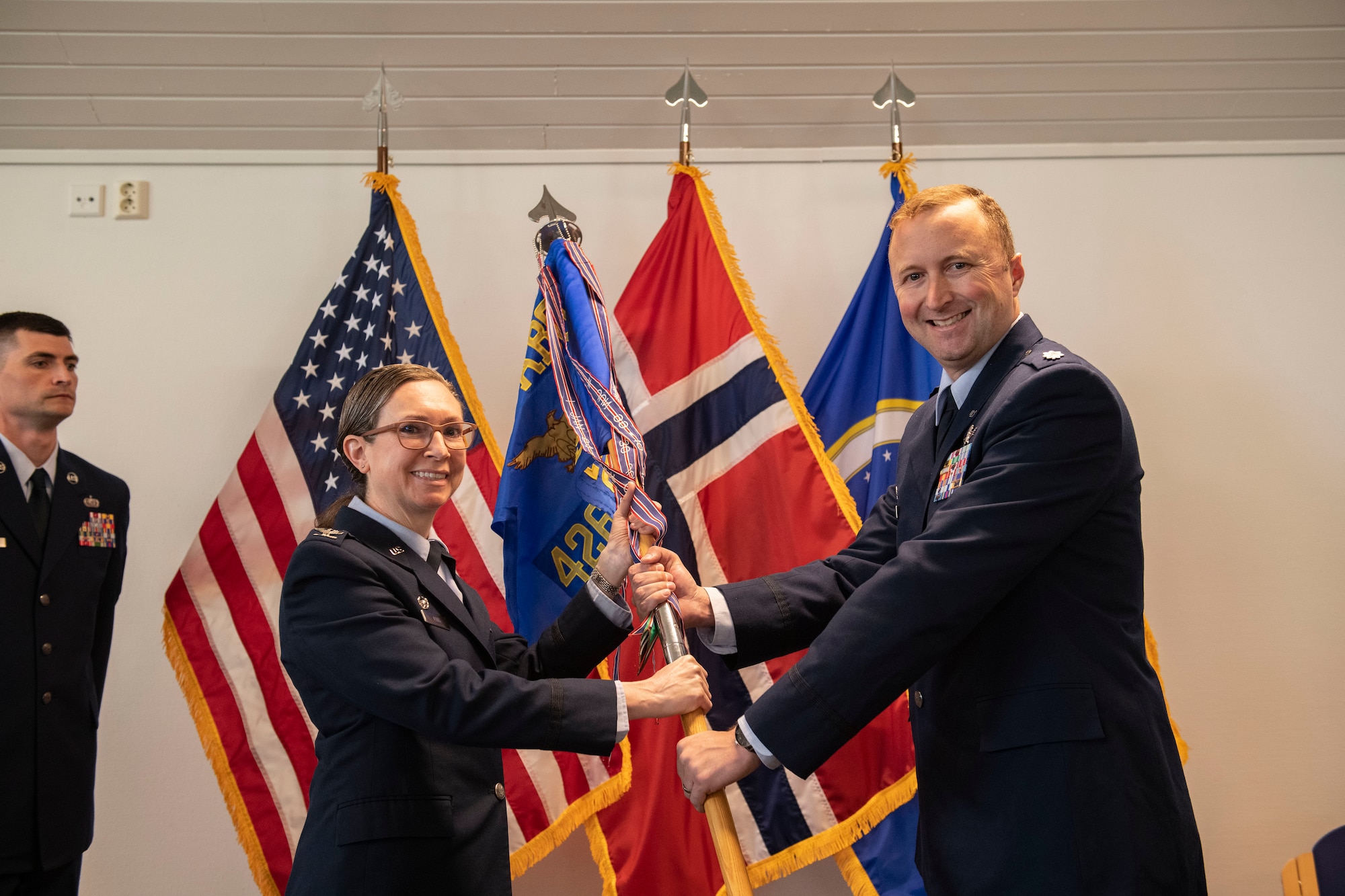 Lt. Col. Daniel A. Hayes, 426th Air Base Squadron incoming commander, right, accepts command from Col. Valarie A. Long, 423d Air Base Group commander, during the 426th ABS change of command ceremony on Jåttå Military Compound, Norway