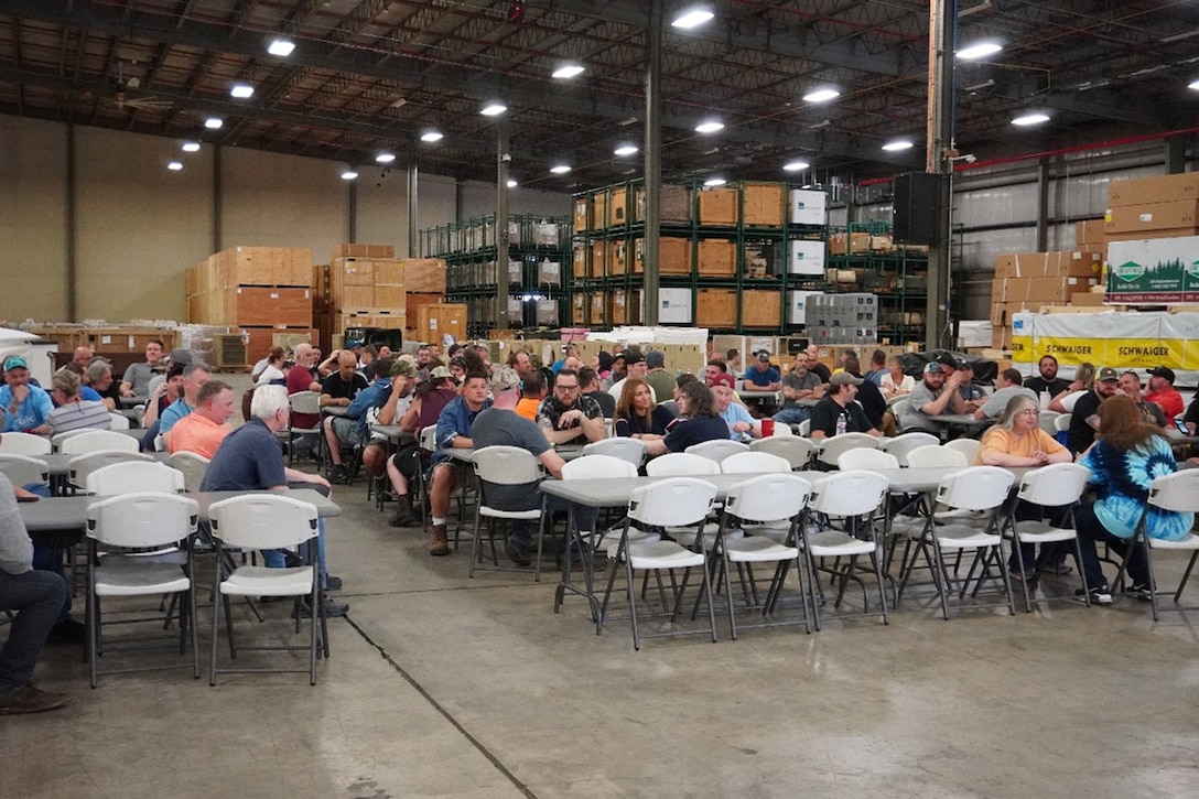 People eating in a warehouse.