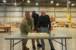People cutting an Army Birthday cake.