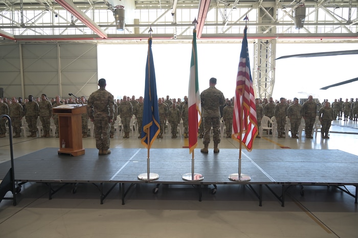 A large group of military members stand together