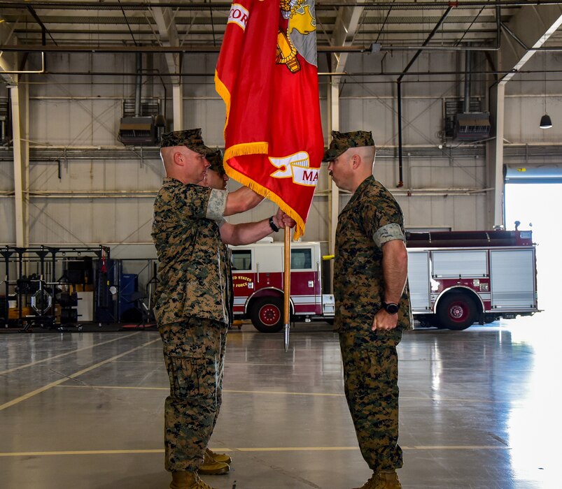 U.S. Marine Corps Master Gunnery Sgt. Darry Cross, Marine Corps Detachment Goodfellow senior enlisted advisor, delivers the detachment colors to Lt. Col. Thomas Coyle, outgoing MCD Goodfellow commander, during the change of command ceremony at the Louis F. Garland Department of Defense Fire Academy, Goodfellow Air Force Base, Texas, June 18, 2024. The passing of the detachment colors is a tradition that symbolizes the passing of leadership from one commanding officer to the next. (U.S. Marine Corps photo by Cpl. Jessica Roeder)